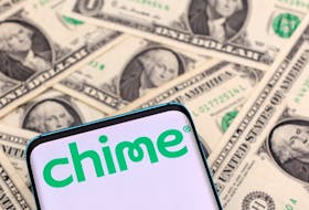 The Chime logo is seen on a smartphone placed on U.S. dollars banknotes in this illustration taken January 24, 2022.