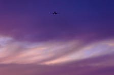 A commercial airliner takes off into an evening sky as it departs San Diego, California, U.S. May 25, 2021.   Mike Blake/REUTERS/ File Photo