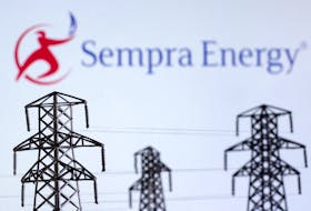 Electric power transmission pylon miniatures and Sempra Energy logo are seen in this illustration taken, December 9, 2022.
