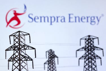 Electric power transmission pylon miniatures and Sempra Energy logo are seen in this illustration taken, December 9, 2022.