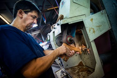 A worker smoothes the sole of a shoe in a shoe making factory, as small and medium-sized businesses struggle amid rising inflation, on the outskirts of Buenos Aires, Argentina, May 4, 2023.