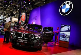 Visitors look at the BMW XM hybrid electric vehicle at the Beijing International Automotive Exhibition, or Auto China 2024, in Beijing, China, April 25, 2024.