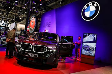 Visitors look at the BMW XM hybrid electric vehicle at the Beijing International Automotive Exhibition, or Auto China 2024, in Beijing, China, April 25, 2024.