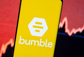 The Bumble logo is seen on a smartphone in front of a stock graph in this illustration taken February 11, 2021.