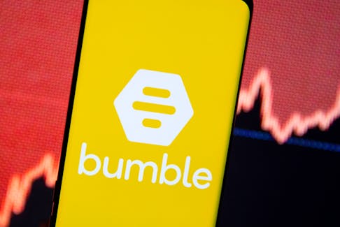 The Bumble logo is seen on a smartphone in front of a stock graph in this illustration taken February 11, 2021.