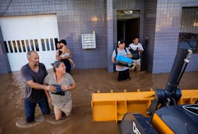 Evacuees react while leaving a flooded area at Eldorado do Sul, in Rio Grande do Sul Brazil May 7, 2024.