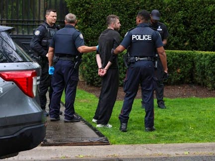 Toronto Police officers are pictured as they arrest a man – described as a “person in crisis” – under the Mental Health Act at Drake’s Bridal Path mansion on May 8, 2024. (Jack Boland, Toronto Sun)