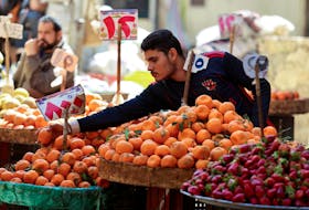 An Egyptian fruit seller works at a market in Cairo, Egypt, March 7, 2024