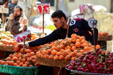 An Egyptian fruit seller works at a market in Cairo, Egypt, March 7, 2024