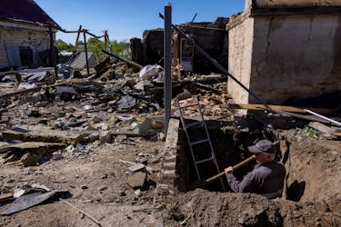 A worker digs to uncover a gas pipe leading to a house that was destroyed during a Russian missile strike, amid Russia’s attack on Ukraine, in Krasylivka, Kyiv region, Ukraine, May 8, 2024.