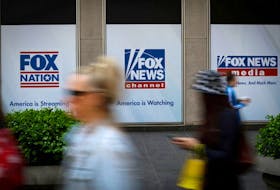 People walk past Fox News posters on the exterior of the News Corporation and Fox News headquarters building in Manhattan in New York City, New York, U.S., April 24, 2023.