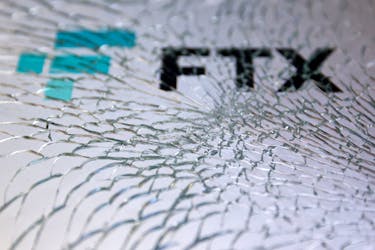 An FTX logo is seen through broken glass in this illustration taken, December 13, 2022