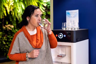 A worker tastes drinking water, that has been extracted from the air, at the office of Watergen, in Petah Tikva, Israel March 27, 2024.