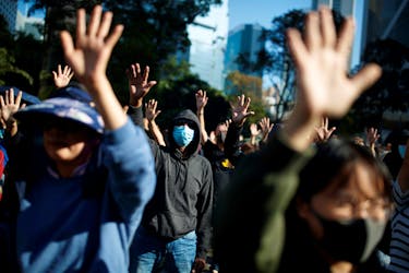 People raise their hands as they sing the protest anthem "Glory to Hong Kong" during an anti-government protest in the Central district of Hong Kong, China, November 30, 2019. 
