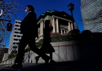 Pedestrians walk past the Bank of Japan building in Tokyo, Japan March 18, 2024.