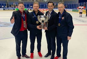 Head coach Gardiner MacDougall, left, of Bedeque, P.E.I., and Hockey Canada’s manager of medical services Kevin Elliott, right, of Charlottetown join assistant coach Travis Crickard, second right, and equipment manager A.J. Murley for a photo with the International Ice Hockey Federation (IIHF) world under-18 male hockey championship trophy. Team Canada defeated the United States 6-4 in the gold-medal game in Espoo, Finland, on May 4. Crickard, head coach of the Quebec Maritimes Junior Hockey League’s (QMJHL) Saint John Sea Dogs, and Murley are from St. John’s. Photo Courtesy of Gardiner MacDougall • Special to The Guardian