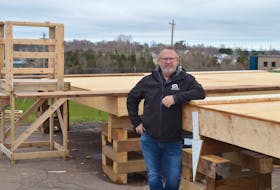 Sam Sanderson, general manager of the P.E.I. Construction Association, stands in front of two affordable small homes under construction at the association’s headquarters in Charlottetown. Dave Stewart • The Guardian