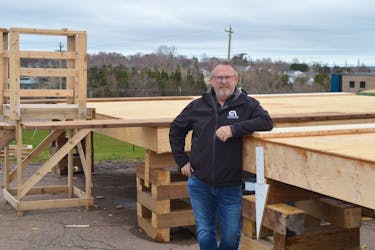 Sam Sanderson, general manager of the P.E.I. Construction Association, stands in front of two affordable small homes under construction at the association’s headquarters in Charlottetown. Dave Stewart • The Guardian