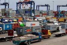 Trucks transporting containers with imported items are prepared to leave a port in Manila, Philippines May 25, 2016.
