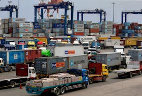 Trucks transporting containers with imported items are prepared to leave a port in Manila, Philippines May 25, 2016.