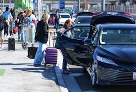 Passengers board Uber ride-share cars after arriving at Los Angeles International Airport (LAX) in Los Angeles, California, U.S. July 10, 2022. 