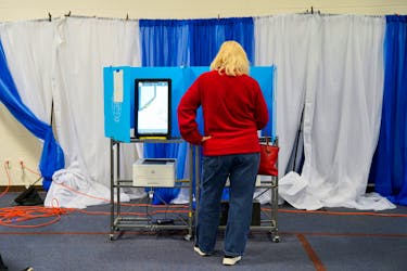 A voter casts their ballot during the midterm runoff elections at Canaan Baptist Church in Columbus, Georgia, U.S., December 6, 2022.