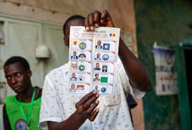 A poll worker holds a ballot during ballot counting at a polling station during presidential election in N'Djamena, Chad May 6, 2024.