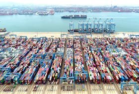 An aerial view shows containers and cargo vessels at the Qingdao port in Shandong province, China May 9, 2022. China Daily via