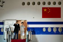 Chinese President Xi Jinping and his wife Peng Liyuan wave as they arrive at the Ferenc Liszt International Airport in Budapest, Hungary, May 8, 2024.   SZILARD KOSZTICSAK/Pool via REUTERS