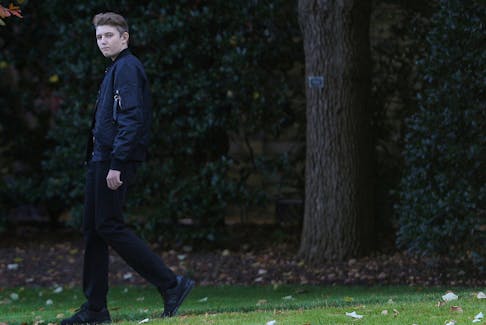 Barron Trump, son of U.S. President Donald Trump, walks to the Marine One helicopter with his parents as they depart for travel to Florida from the South Lawn of the White House in Washington, U.S., November 26, 2019.