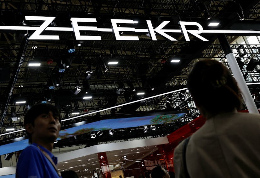 Visitors walk past the Zeekr logo, at the Beijing International Automotive Exhibition, or Auto China 2024, in Beijing, China, April 25, 2024.