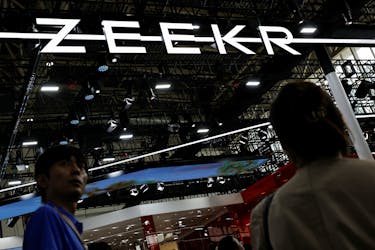 Visitors walk past the Zeekr logo, at the Beijing International Automotive Exhibition, or Auto China 2024, in Beijing, China, April 25, 2024.