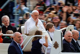 Pope Francis waves at people on the day of the weekly general audience, in St. Peter's Square at the Vatican, May 8, 2024.