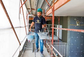 A builder from Pierluigi Fusco's firm works at a construction site of energy-saving building, making apartments more energy-efficient under government "superbonus" incentives, in Caserta, southern Italy, June 21, 2022. Picture taken June 21, 2022.