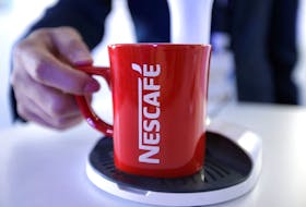 An employee holds a Nescafe cup at Nestle R&D Center in Beijing, China, March 25, 2019. Picture taken March 25, 2019.