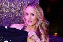 Adult-film actress Stephanie Clifford, also known as Stormy Daniels, poses for pictures at the end of her striptease show in Gossip Gentleman club in Long Island, New York, U.S., February 23, 2018.