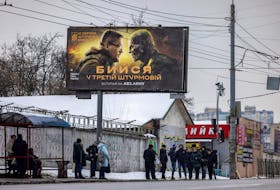 People walk past a poster advertising the 3rd Separate Assault Brigade of the Ukrainian Ground Forces as the country's lawmakers are working on an overhaul of the mobilisation process in Kyiv, amid Russia's attack on Ukraine, January 18, 2024.