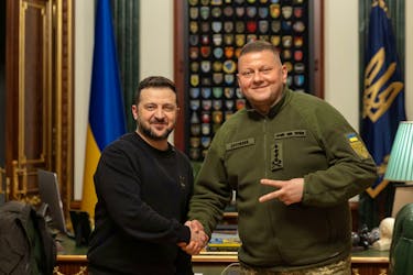 Ukraine's President Volodymyr Zelenskiy and Commander in Chief of the Ukrainian Armed Forces Valerii Zaluzhnyi shake hand and pose for a picture during their meeting, amid Russia's attack on Ukraine, in Kyiv, Ukraine February 8, 2024. Ukrainian Presidential Press Service/Handout via