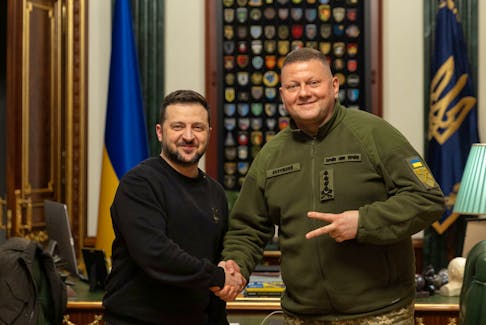 Ukraine's President Volodymyr Zelenskiy and Commander in Chief of the Ukrainian Armed Forces Valerii Zaluzhnyi shake hand and pose for a picture during their meeting, amid Russia's attack on Ukraine, in Kyiv, Ukraine February 8, 2024. Ukrainian Presidential Press Service/Handout via