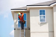 A carpenter works on new townhomes that are still under construction while building material supplies are in high demand in Tampa, Florida, U.S., May 5, 2021. 
