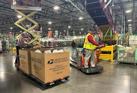 Employees work as the largest United States Postal Service (USPS) facility gears up for the busiest shipping time of the year, in Los Angeles, California, U.S. November 30, 2023.