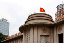 A Vietnamese flag flies atop the State Bank building, near the Vietcombank and Bank for Investment and Development of Vietnam buildings, in central Hanoi, Vietnam November 23, 2017.