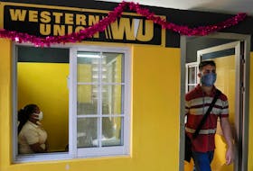 A client leaves a Western Union office in Havana, Cuba, November 23, 2020. 