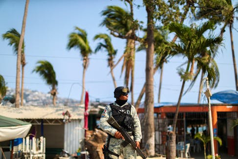 A member of the National Guard stands guard at a crime scene where two people were shot in Acapulco, Mexico, May 7, 2024.