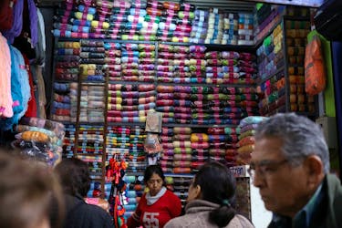A woman sells cloth trimmings at a stand at Surco market in Lima, Peru August 31, 2018. 