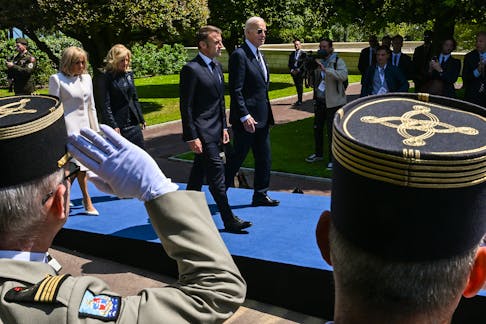 
          U.S. President Joe Biden, First Lady Jill Biden, French President Emmanuel Macron, and First Lady Brigitte Macron walk into the D-Day Anniversary Commemoration Ceremony at Normandy American Cemetery, France, June 6, 2024. The president's decision, on the eve of the summer Olympic Games that begin in Paris in July, ushered in a period of deep political uncertainty in France. (Kenny Holston/The New York Times)
        