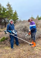 Harry Delorey, left, and Chris Cook clean up the Wilmot Cemetery in Canso, N.S. – Contributed