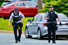 RCMP officers return to their vehicles after responding to a murder on Agincourt Crescent in Cole Harbour, Sunday June 9, 2024. A 76 yr old man has been charged with murder after being taken into custody on the scene. A 74 year old woman was found deceased. 

TIM KROCHAK PHOTO