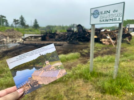 A postcard of the Bangor Sawmill and Museum found among the charred debris was a poignant reminder of the loss to the community from an early morning June 8 fire that destroyed this iconic and historic structure along the Meteghan River in the Municipality of Clare. TINA COMEAU