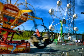 The Thomas Amusements ride Tornado spins around as the Rock-O-Plane sits in the background at their site at the Jack Byrne Arena in Torbay Tuesday.

Keith Gosse/The Telegram